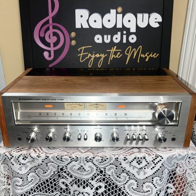Pioneer SX-650 vintage stereo receiver in Ottawa Valley cherry cabinet — front view of silver faceplate