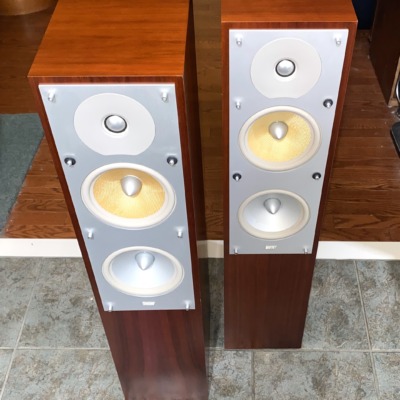 B&W CM4 towers in Rosenut, pair — angled view showing the driver array and cabinet grain