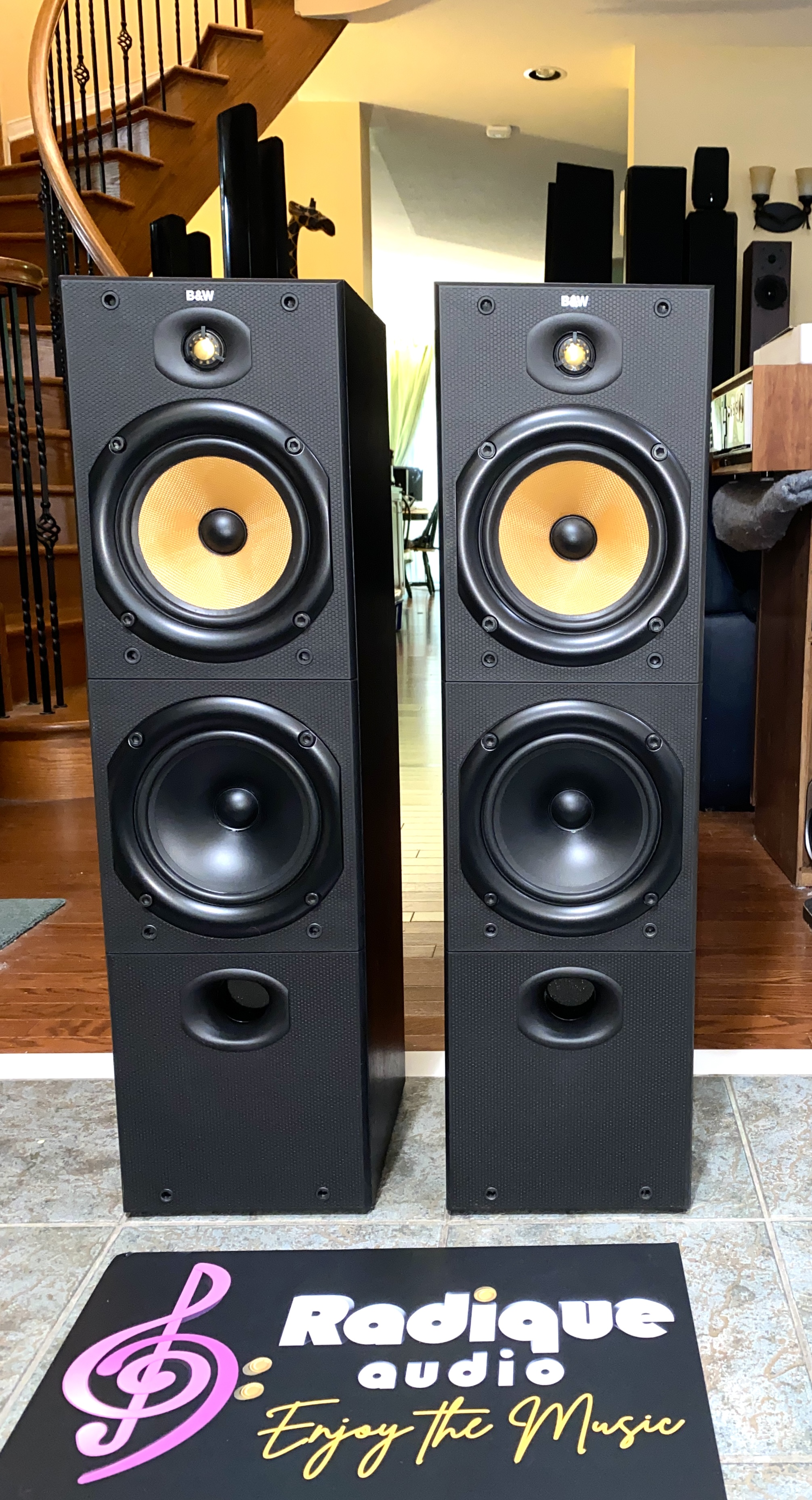 BW-DM603-august-2025-01 B&W DM603 three-driver floorstanding speakers, pair — front view showing the yellow Kevlar midrange and dual woofers