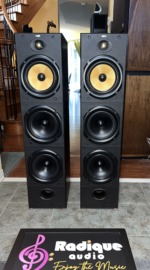 B&W DM604 S1 Kevlar tower speakers, pair — front view showing the yellow Kevlar midrange drivers and dual woofers