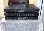 NHT Evolution T5 system electronics — rear panels of the three outboard units showing inputs, outputs and power connections
