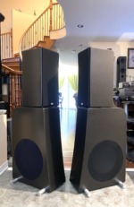 NHT Evolution T5 towers, pair — front-left angle showing the slim upper modules atop the powered 12-inch subwoofer cabinets