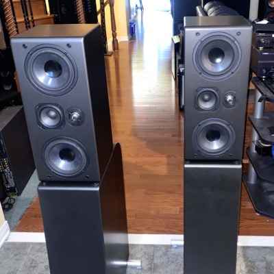 NHT Evolution T5 tower speakers, pair — angled room view showing full height on their powered subwoofer bases