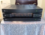 NHT Evolution T5 system electronics — three outboard amplifier and crossover units stacked, front view