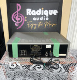 Onkyo TA-2040 rear panel — RCA jacks and mains lead, green tape across the cabinet