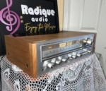Pioneer SX-750 vintage receiver in cherry cabinet — angled front view showing the faceplate and cherry side panel