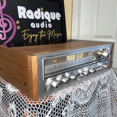 Pioneer SX-750 vintage receiver in cherry cabinet — angled front view showing the faceplate and cherry side panel