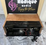 Pioneer SX-750 vintage receiver in cherry cabinet — rear three-quarter view showing the ventilated top and rear panel