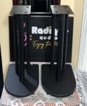 Three-post steel speaker stands from above — top plates and the wide bases