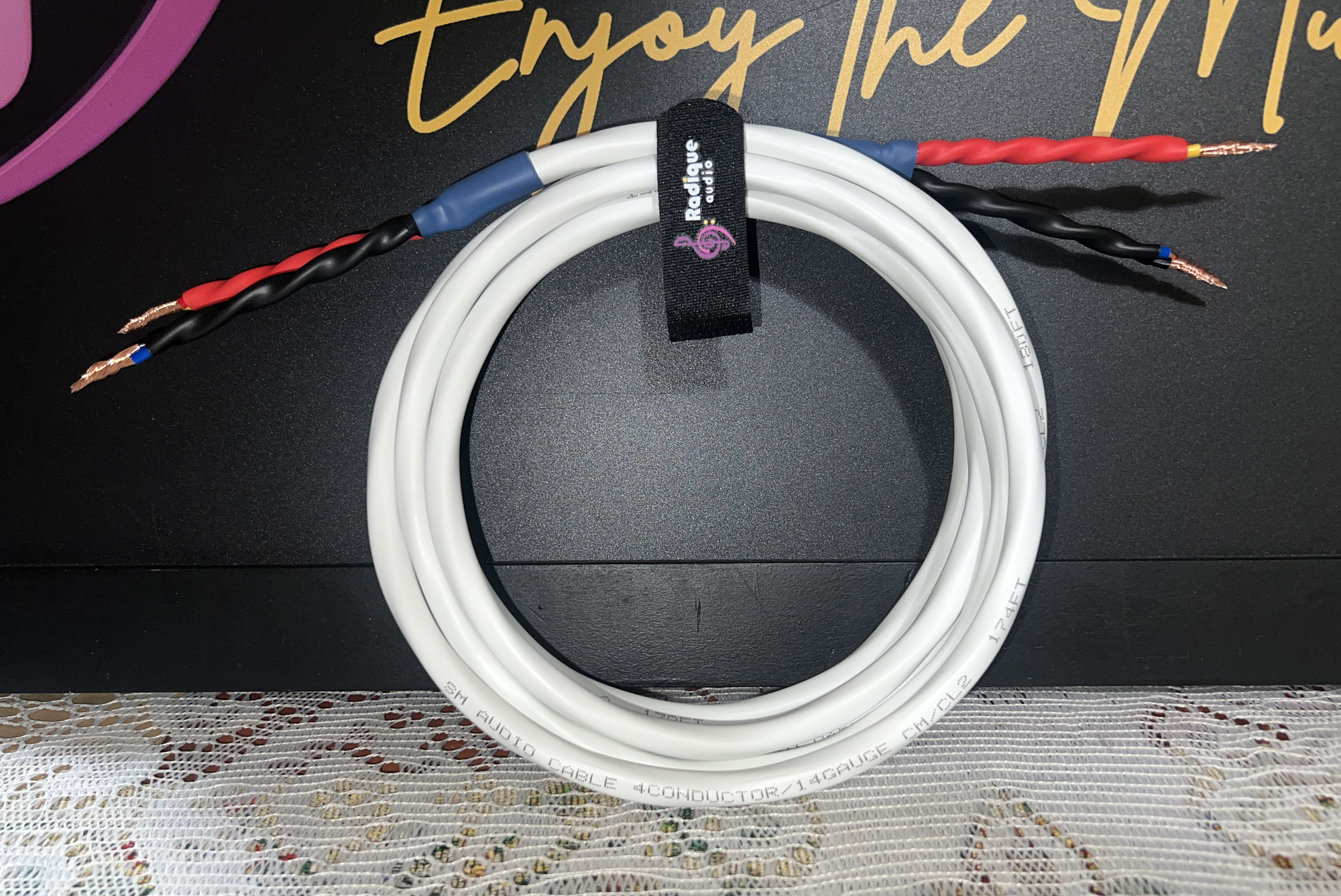 Finished Radique Audio House Quad speaker cable coiled on a branded strap, both ends terminated bare with colour-coded heat-shrink