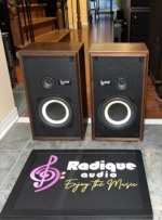 Pair of Avant 1AX speakers in walnut cabinets, grilles off, showing woofers, tweeters and model badges