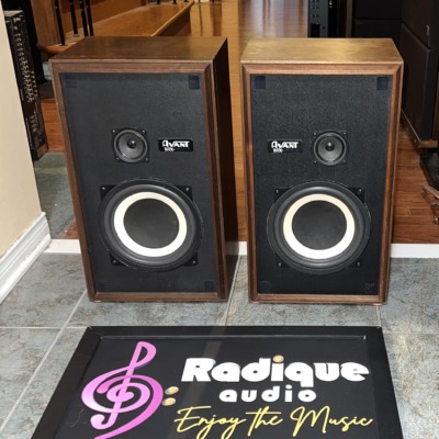 Pair of Avant 1AX speakers in walnut cabinets, grilles off, showing woofers, tweeters and model badges