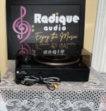 Dual 1214 with the dust cover closed, the Dual CS 16 base label and the bundled power cord and RCA leads in front
