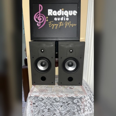 Energy Connoisseur C-2 bookshelf speakers in high gloss black with grilles off, showing the tweeter, silver-cone woofer and front bass port