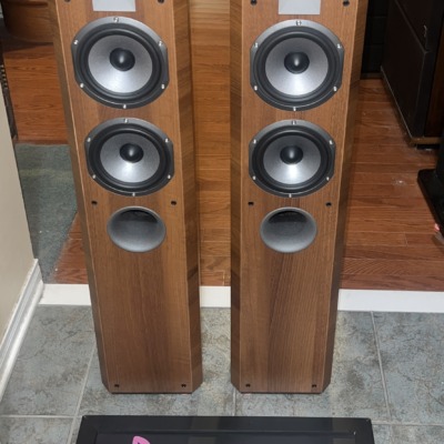 Pair of Focal Chorus 714V towers at a slight angle, Light Walnut cabinets with the full driver array and tweeter faceplate in view