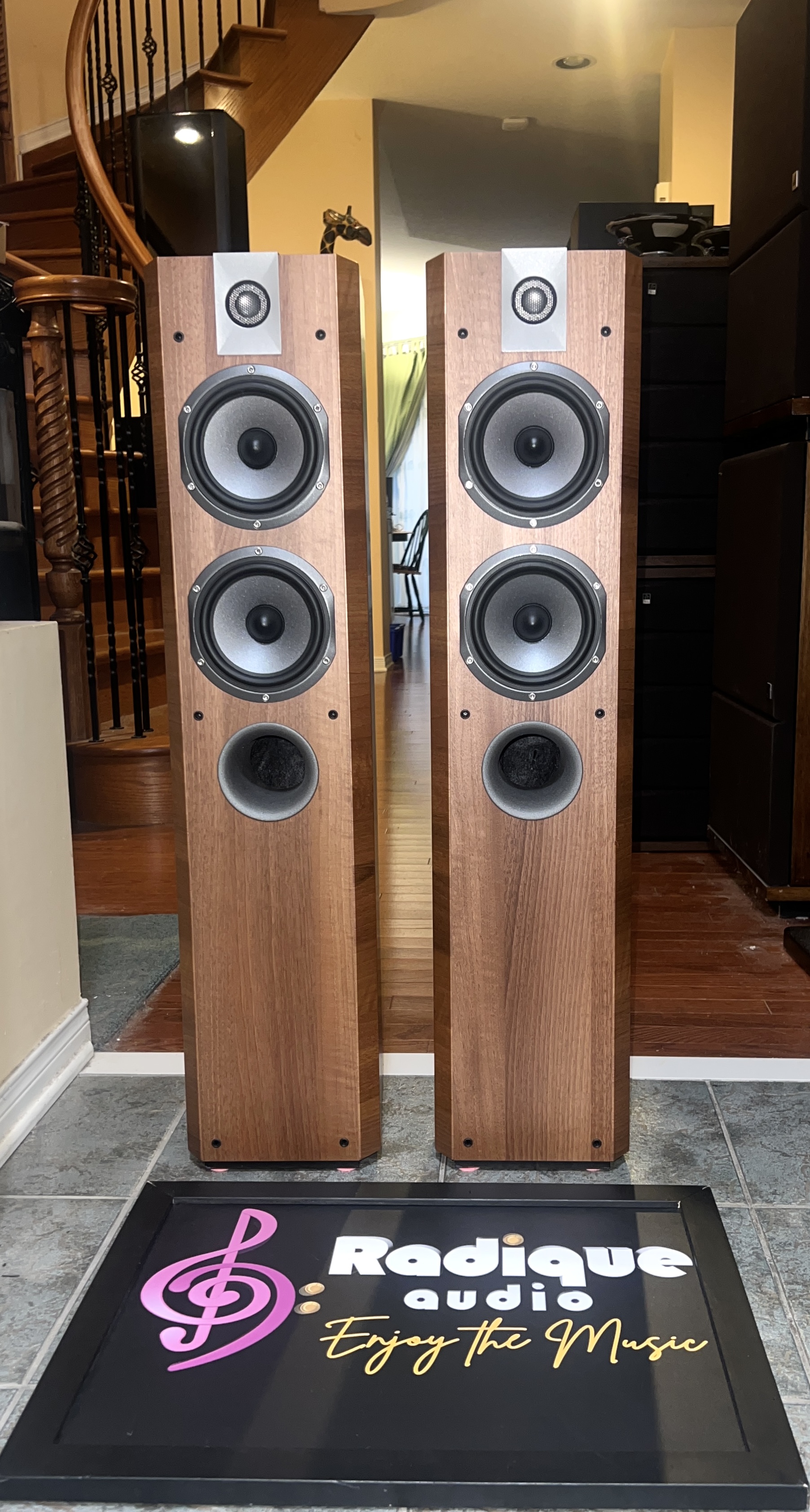 Focal-Chorus-714V-Floorstanding-Speakers-Walnut-Front Focal Chorus 714V floorstanding speakers in Light Walnut, grilles off, each with an inverted dome tweeter above two midrange cones and a lower bass driver