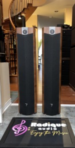 Focal Chorus 714V speakers with the black cloth grilles fitted, Light Walnut tops and the Focal badge at the foot of each grille