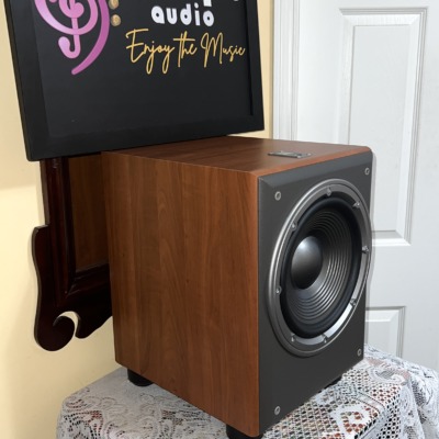 JBL Northridge E150P subwoofer at an angle, cherry side panel and the exposed 10 inch driver on the front baffle