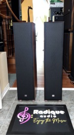 JBL Northridge E80 tower pair standing straight on with their full-length black cloth grilles fitted