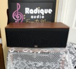 JBL Northridge EC35 centre speaker straight on with its black grille fitted, cherry top and the JBL badge at the base