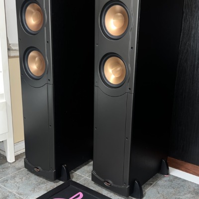 Klipsch RF-62 floorstanding speakers from the left with grilles off, horn tweeter above two copper woofers on each tower