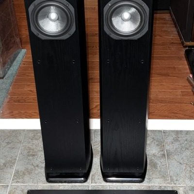 Pair of Mirage OMNI 350 tower speakers in black ash, grilles off, showing the omnipolar tweeters and woofers