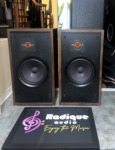 Original Large Advent speakers with grilles off, walnut cabinets and black baffles, orange-ringed dome tweeter above a large woofer
