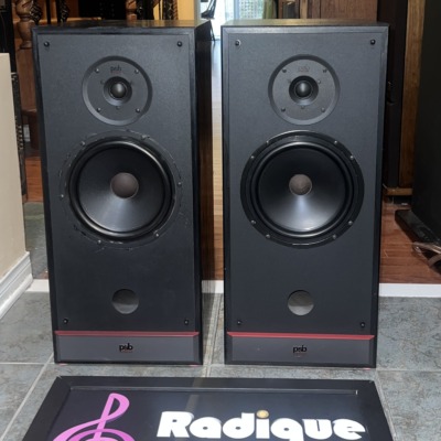 Pair of PSB 50 MkII speakers in black ash, grilles off, tweeter over woofer with a front port and red trim strip at the base