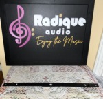 The wall-mount rail supplied with the Paradigm Millenia 20 LCR speaker, a long black steel bracket laid flat in front