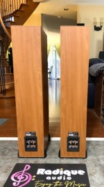 Rear of the Paradigm Monitor 7 v2 tower pair in light cherry, with the binding-post terminal plates low on each cabinet