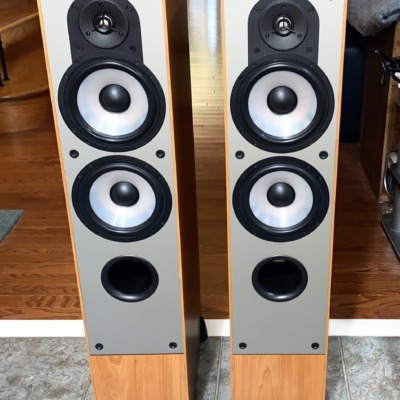 Pair of Paradigm Monitor 7 v2 tower speakers in light cherry, grilles off, tweeter over three woofers on silver baffles