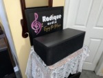 Paradigm Studio CC v2 center channel with the grille on, seen at an angle to show the depth of the black cabinet
