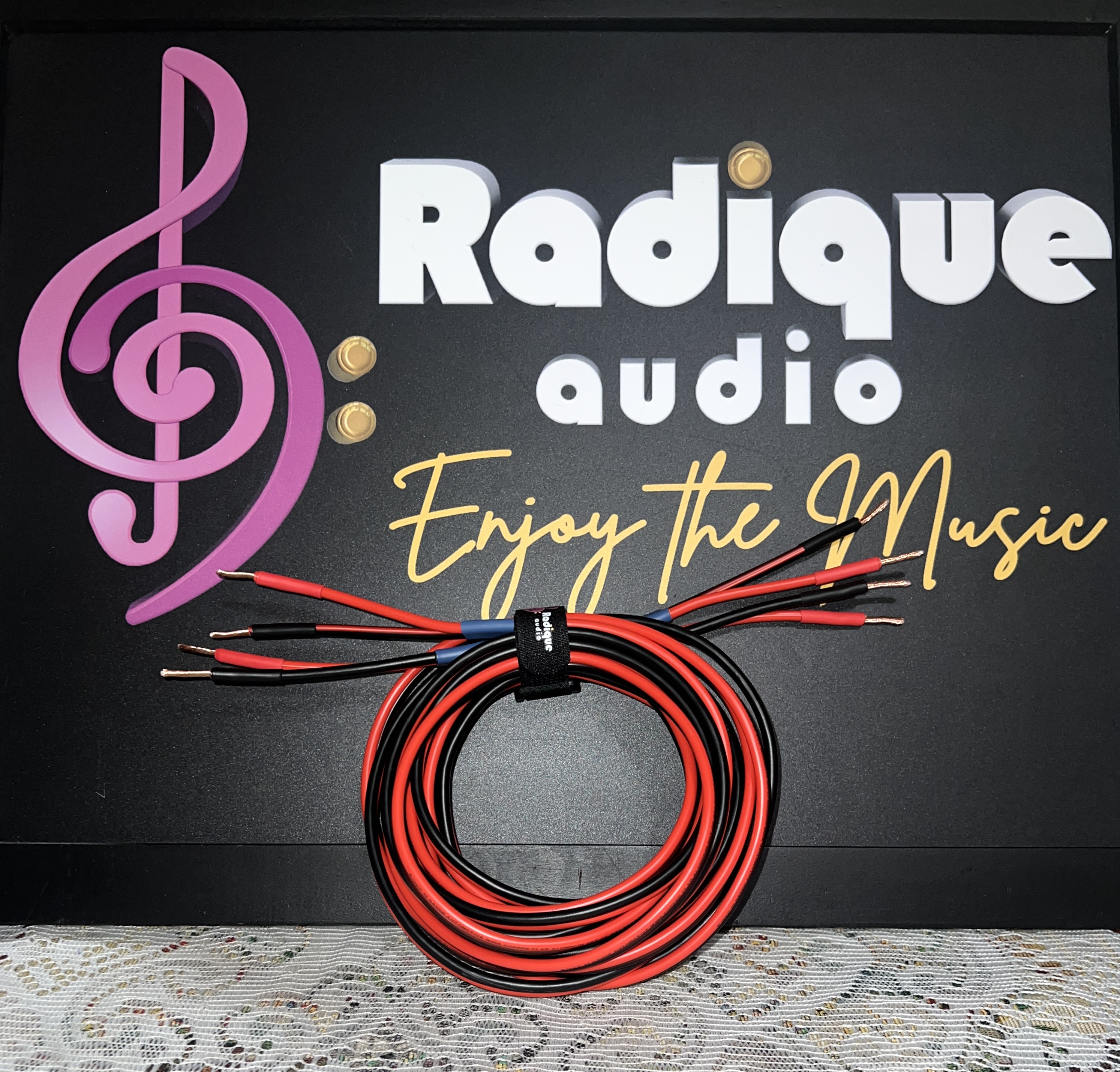Radique-House-CCA-Speaker-Cables-10-ft-Pair-Front Pair of Radique house CCA speaker cables, 10 feet, red and black, coiled and strapped with stripped bare-wire ends