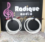 Both Radique House Quad cable runs laid flat against the Radique Audio board, twisted red and black tails fanned out to gold-pin banana plugs