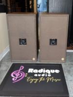 Rear of the Realistic Optimus-21 speaker pair, brown back panels with a speaker terminal cup and a label on each