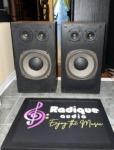 Pair of Realistic Optimus-21 three-way speakers, grilles off, twin tweeters above a large woofer, walnut-grain sides