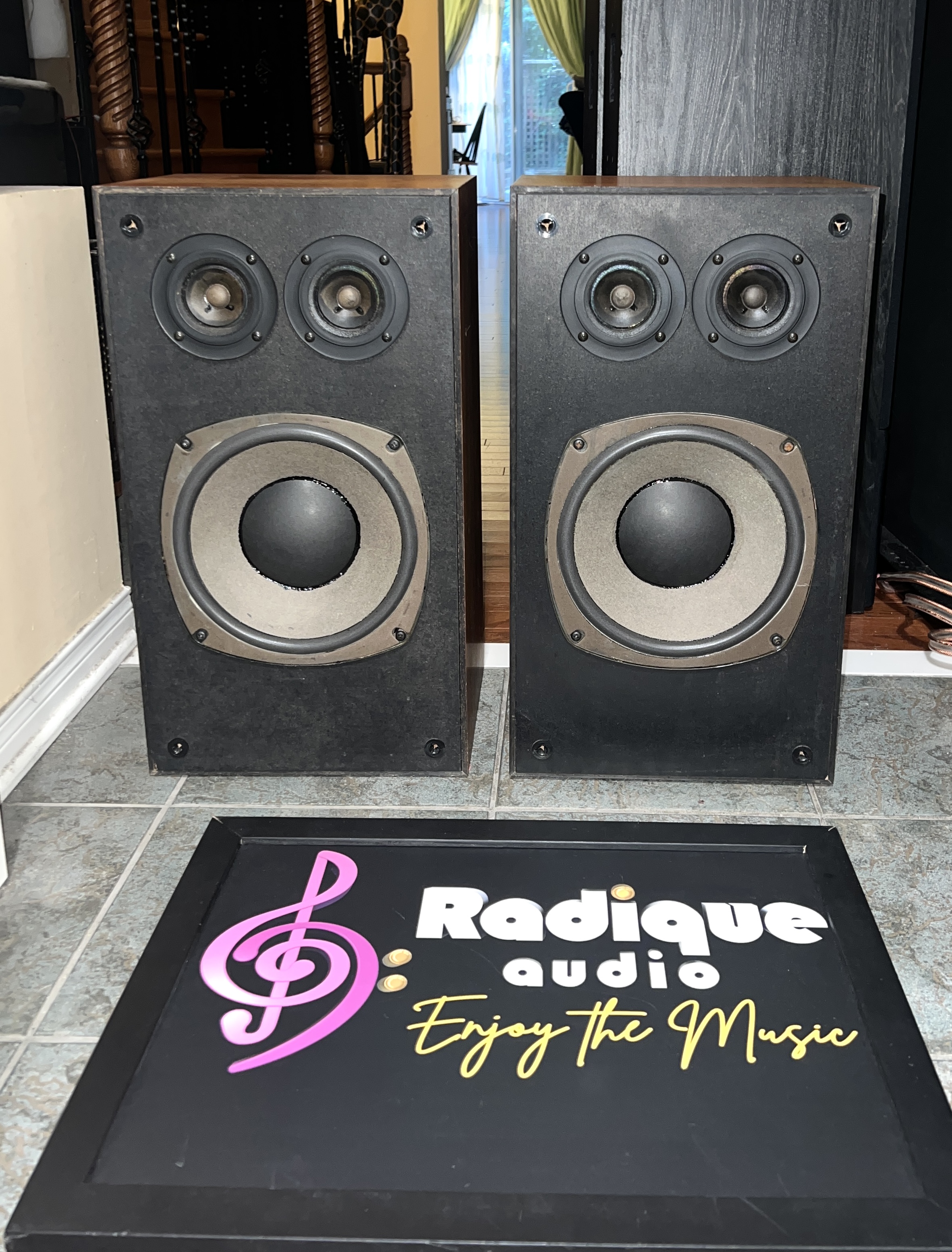 Realistic-Optimus-21-Speakers-Walnut-Front Pair of Realistic Optimus-21 three-way speakers, grilles off, twin tweeters above a large woofer, walnut-grain sides