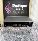 Rear panel of the Rotel RC-1550 with rows of RCA inputs and outputs, 12V trigger and IR jacks, and the model label
