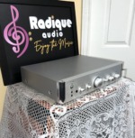 Angled view of the silver Rotel RC-1550 preamplifier showing the brushed faceplate, input selector knobs and side panel