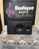 Tannoy D5C centre channel speaker in black ash, grille off, showing the woofer, tweeter and port
