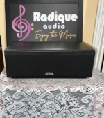 Tannoy Mercury mxC-M centre speaker in dark oak wearing the black cloth grille, the alternative to the silver-grey option
