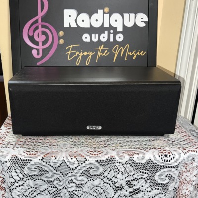 Tannoy Mercury mxC centre speaker in dark oak wearing the black cloth grille, the alternative to the silver-grey option