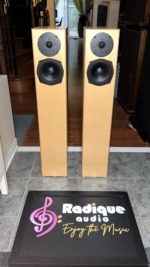 Pair of Totem Acoustic Sttaf floorstanding speakers in maple veneer, front view with grilles off showing the tweeter and 5.5-inch driver