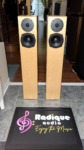 Pair of Totem Acoustic Sttaf floorstanding speakers in maple veneer, front view with grilles off showing the tweeter and 5.5-inch driver