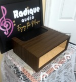 Side view of the empty WC-10 walnut case, long wood flank and squared top edge with the open front facing right