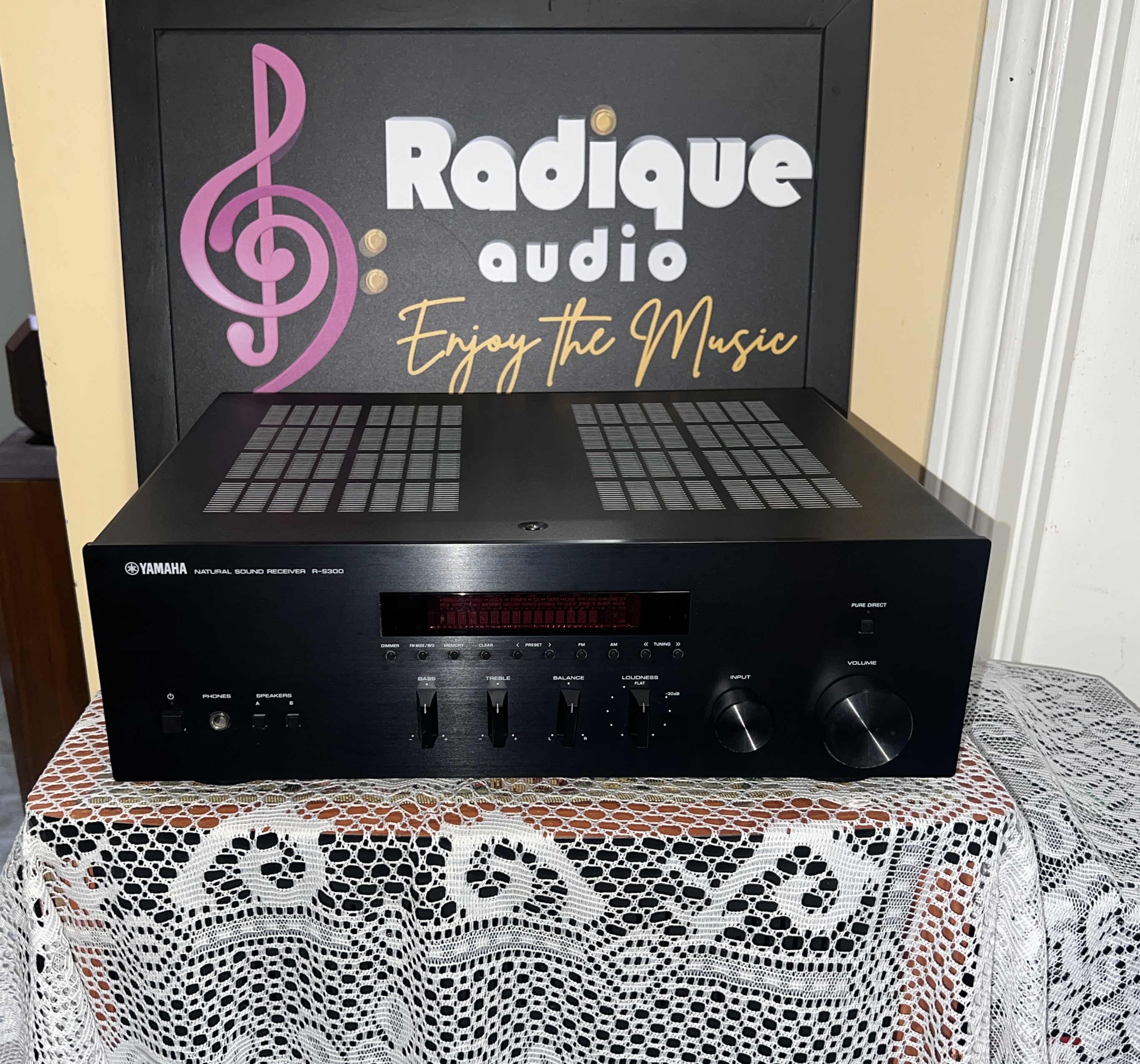 Yamaha-R-S300-Stereo-Receiver-Front Yamaha R-S300 Natural Sound stereo receiver in black, with its red display window, bass and treble sliders and a large volume knob