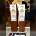 B&W CM4 floorstanding speakers in Rosenut, pair — front view of the silver Nautilus drivers and rosenut cabinets