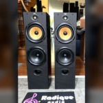 B&W DM603 three-driver floorstanding speakers, pair — front view showing the yellow Kevlar midrange and dual woofers
