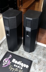 Bose 701 Series I tower speakers from a raised front angle, showing the angled upper grille panels and black ash cabinets
