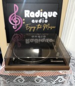 Dual 504 belt-drive turntable straight on in its real wood walnut plinth with the smoked dust cover closed